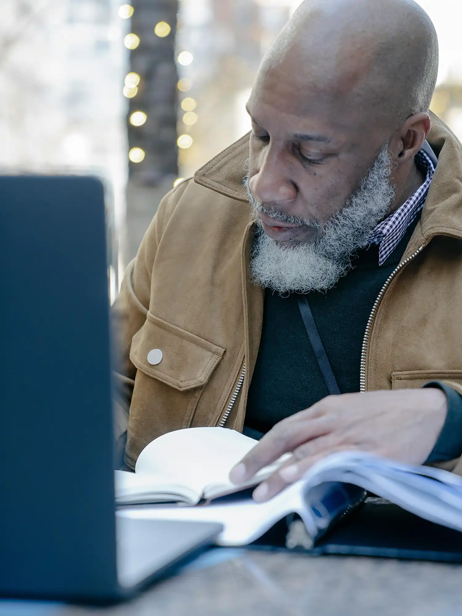 Blackman on laptop and writing