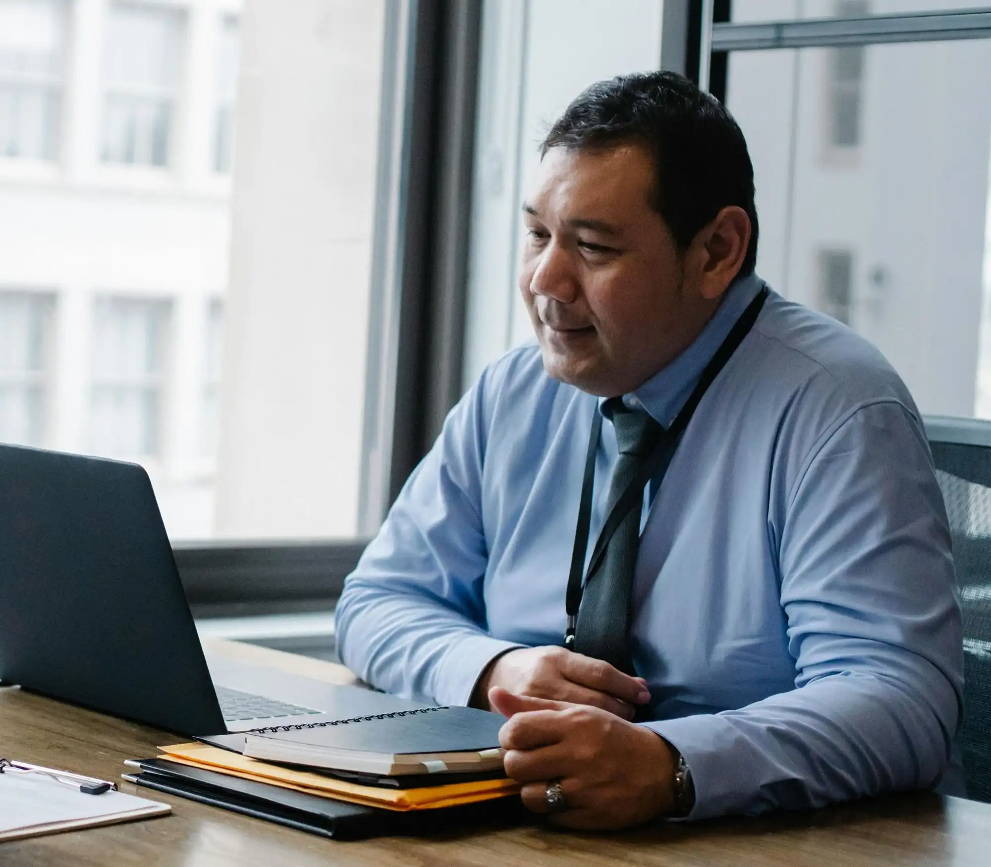 Hispanic man at desk with laptop revised resized copy