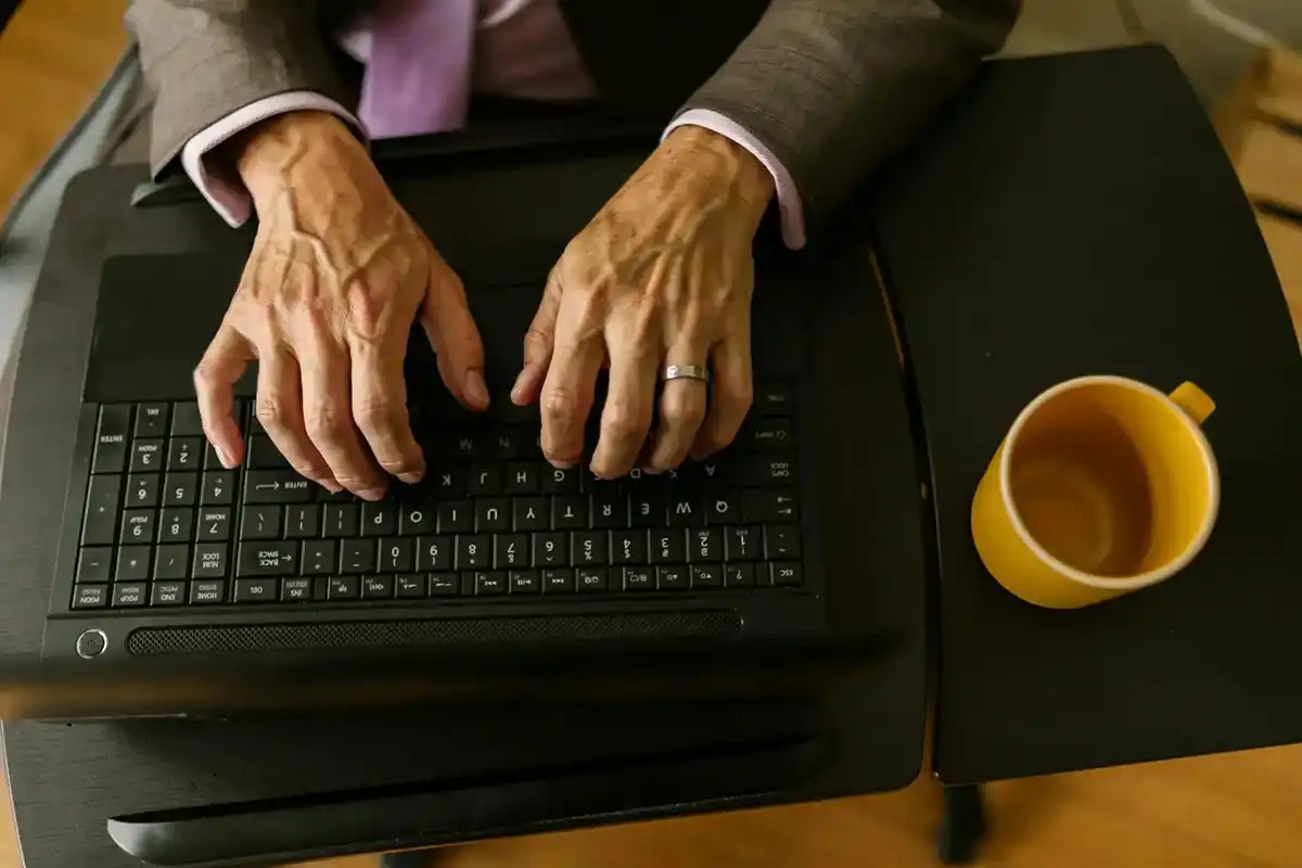 old hands on laptop resized